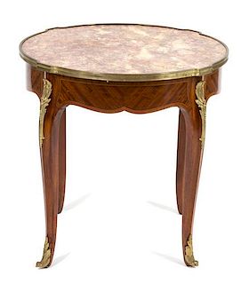 A Louis XV Style Marble Top Gilt Metal Mounted Table Height 22 1/2 x diameter 23 1/4 inches.