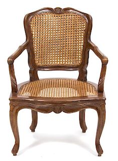 A Louis XV Style Walnut Cane Back and Seat Fauteuil Height 33 x width 23 1/2 x depth 23 inches.