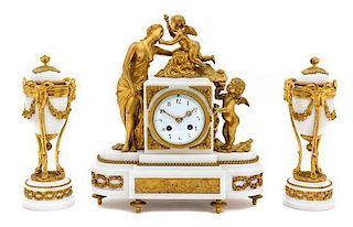 A Louis XVI Style Gilt Bronze Mounted White Marble Clock Garniture Height of clock 14 1/2 inches.