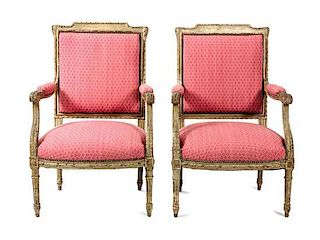 A Pair of Louis XVI Style Carved and Painted Fauteuils Height 38 1/2 x width 24 x depth 21 inches.