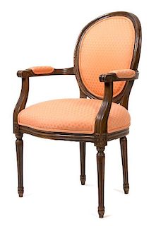 A Louis XVI Style Carved Walnut Fauteuil Height 39 1/2 inches.