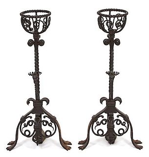 A Pair of Jacobean Style Wrought Iron Fire Dogs Height 29 1/2 inches.