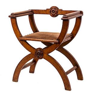 An English Arts & Crafts Carved Oak Savanarola Chair Height 31 1/2 inches.