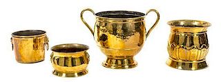 A Group of Four Hammered Brass Planters Largest: height 14 x diameter 14 inches.
