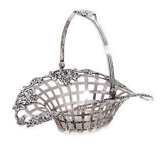 A Birks Sterling Silver Reticulated Basket, 20th century, having a grapevine border and swing handle.