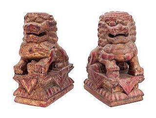 A Pair of Chinese Red and Gold Painted Carved Wood Foo Lions Height 10 1/4 inches.