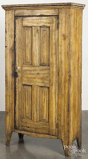 Painted pine wall cupboard, late 19th c., retaining an old ochre grained surface, 61'' h., 30 3/4'' w.