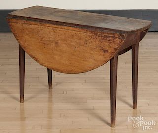 Pine drop leaf table, early 19th c., the base retaining an old red surface, 28'' h., 16 1/2'' w.