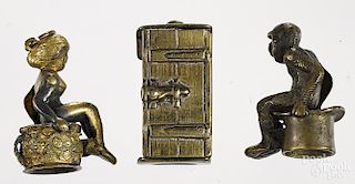 Three figural cigar cutters, to include a brass woman seated in an outhouse, 1 1/8'' h.