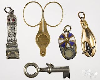 Five figural cigar cutters, to include a sterling silver owl, 1 3/4'' h., a key, a lobster claw