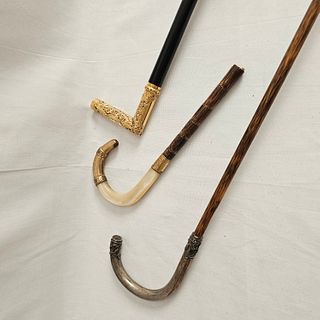 Grouping of Two Walking Sticks and Cane Top