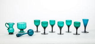 SET OF SIX ENGLISH EMERALD GREEN GLASS WINES; A FUNNEL-SHAPED WINE; A MASHER; FOOTED BOWL; AND A CREAM JUG