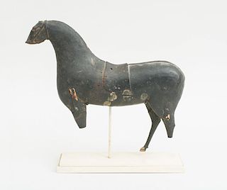 CARVED AND BLACK PAINTED WOOD MODEL OF A HORSE WITH SADDLE
