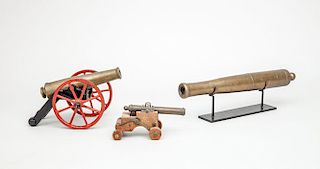 BRASS MODEL OF A CANNON ON CAST-IRON RED AND BLACK PAINTED CHASSIS, AND TWO OTHER BRASS CANNON MODELS