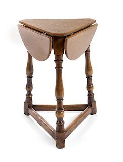 * A Jacobean Style Oak Drop-Leaf Table Height 22 inches.