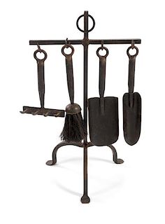 * A Set of Wrought Iron Fire Tools Height of stand 20 inches.
