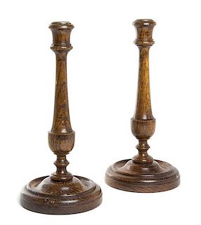 * A Pair of Turned Oak Candlesticks Height 12 inches.