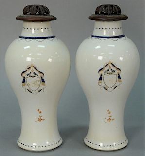 Pair of Chinese export porcelain covered vases with teak tops, each painted with coat of arms. 
(one repaired) 
height 11 inc