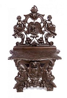 * A Renaissance Style Carved Walnut Hall Chair Height 51 x width 34 1/2 inches.