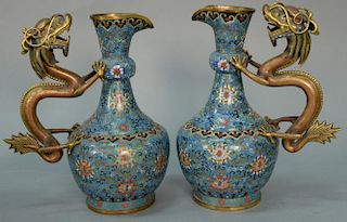 Pair of Chinese cloisonne dragon ewers having scrolling vines and blossoming lotus on blue ground with sculpted enameled drag