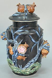Chinese famille noire porcelain covered jar having high relief plants and pomegranate. 
height 12 inches