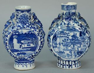 Two Chinese moon shaped vases on footed base, each with circular blue scenes. 
(one top chipped and repaired, one chipped dra