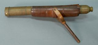 Brass telescope on wood holder with leather covering, 19th century. 
length 22 inches