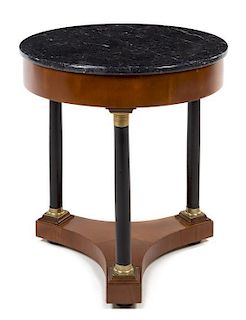* An Italian Empire Style Gilt Metal Mounted and Parcel Ebonized Table Height 25 x diameter of top 23 inches.