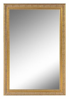 * A Neoclassical Style Giltwood Mirror Height 54 3/8 x width 36 3/8 inches.