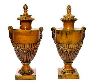 * A Pair of Glazed Terra Cotta Urns Height 28 inches.