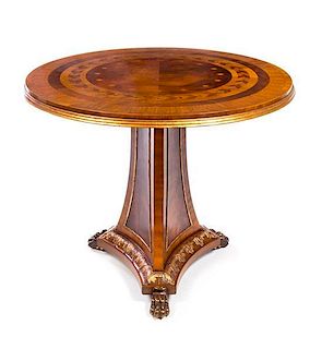 * A Regency Style Parcel Gilt Satinwood and Marquetry Table Height 30 x diameter of top 34 1/2 inches.