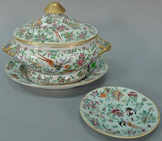 Rose famille twelve piece lot including a covered tureen, oval platter, and ten plates. 
tureen: height 9 inches 
platter: le