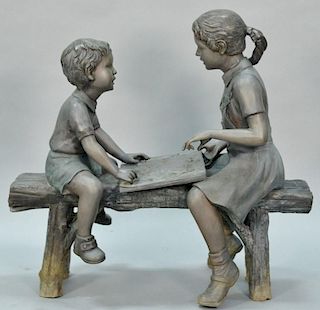 Bronze of young boy and girl on a bench reading a book, signed J.W. Peterson 1998.
height 35 inches, width 36 inches