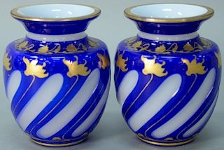 Pair of overlay glass vases, cobalt to white with gold highlights, probably Bohemian. 
height 4 3/4 inches