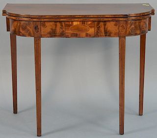 Federal mahogany games table having D shaped top, the conforming frieze with line and panel inlays all set on square tapered 