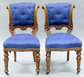 Set of twelve walnut Victorian side chairs having upholstered backs and seats on carved legs. 
height 33 inches