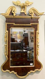 Chippendale mahogany mirror having broken arch top with gilt bird over mirror flanked by fruit and leaves, all with gilt trim