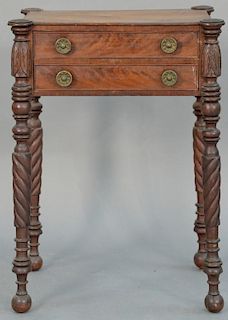 Sheraton mahogany two drawer stand with turret corners on carved turned legs ending in ball feet, Massachusetts circa 1830. 
