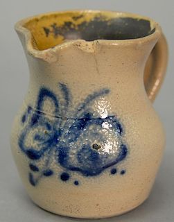 Miniature stoneware pitcher having blue floral decoration and blue spots on handle. (rim chips and small cracks) height 4 i