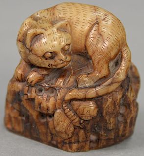 Carved soapstone cat seated on realistic base.  height 2 inches, width 2 inches
