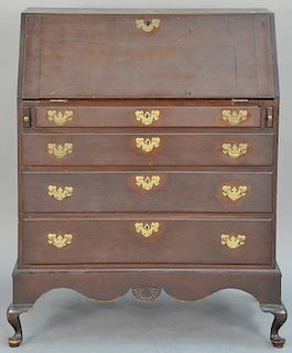 Slant lid cherry desk with serpentine interior and four drawers set on separate base having short bandy legs, circa 1760.  (b