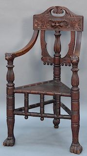 Victorian carved oak three leg armchair with bear's head hand rests and large paw feet. height 46 inches, width 25 inches