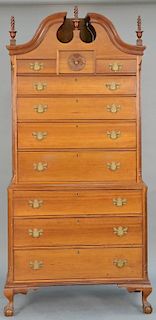 Chippendale cherry chest on chest in two parts, upper portion with full bonnet top and three finials over three short drawers