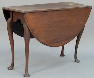 Queen Anne walnut table with oval drop leaves set on cabriole legs ending in pad feet, circa 1750.  (top removed and reversed