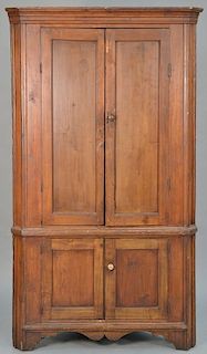 Primitive corner cupboard with cornice molded top over four doors on bracket base, 18th century.  height 77 inches, width 43 