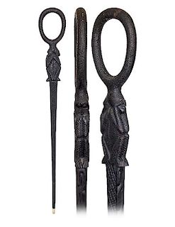 24. Afro-Colonial Ebony Cane -20th Century -The cane is fashioned of a single piece of deep black ebony and carved with a loo