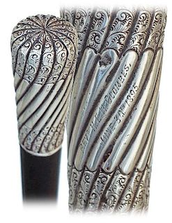 28. Silver Dress Cane -1895 -Substantial and elongated silver knob fashioned with twirling twists, plain in their central par