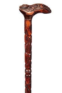 89. Folk Art Alligator Cane- Ca. 1925- A carved full length alligator handle atop a hardwood carved shaft and no ferrule. H.-