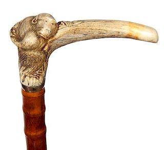 74. Japanese Stag Monkey Cane- Ca. 1890- A carved stag with a large monkey holding fruit behind it’s back, silver metal col