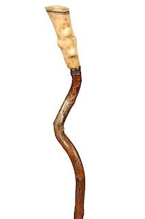 153. Folk Art Bone Cane- Ca. 1840- A carved bone handle with faux twig spurs, small silver metal collar, great grape vine wra
